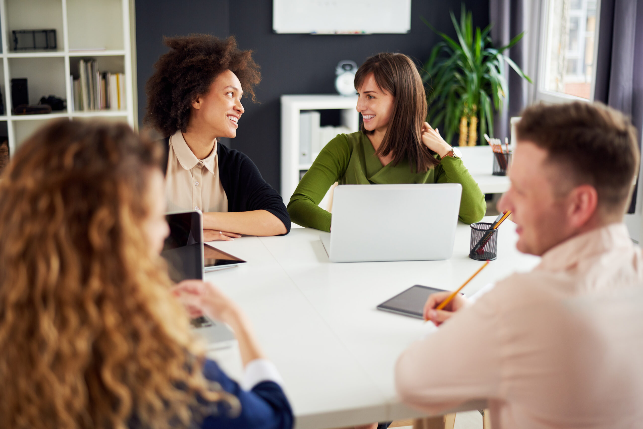 Young people around office table. Employee benefits services.